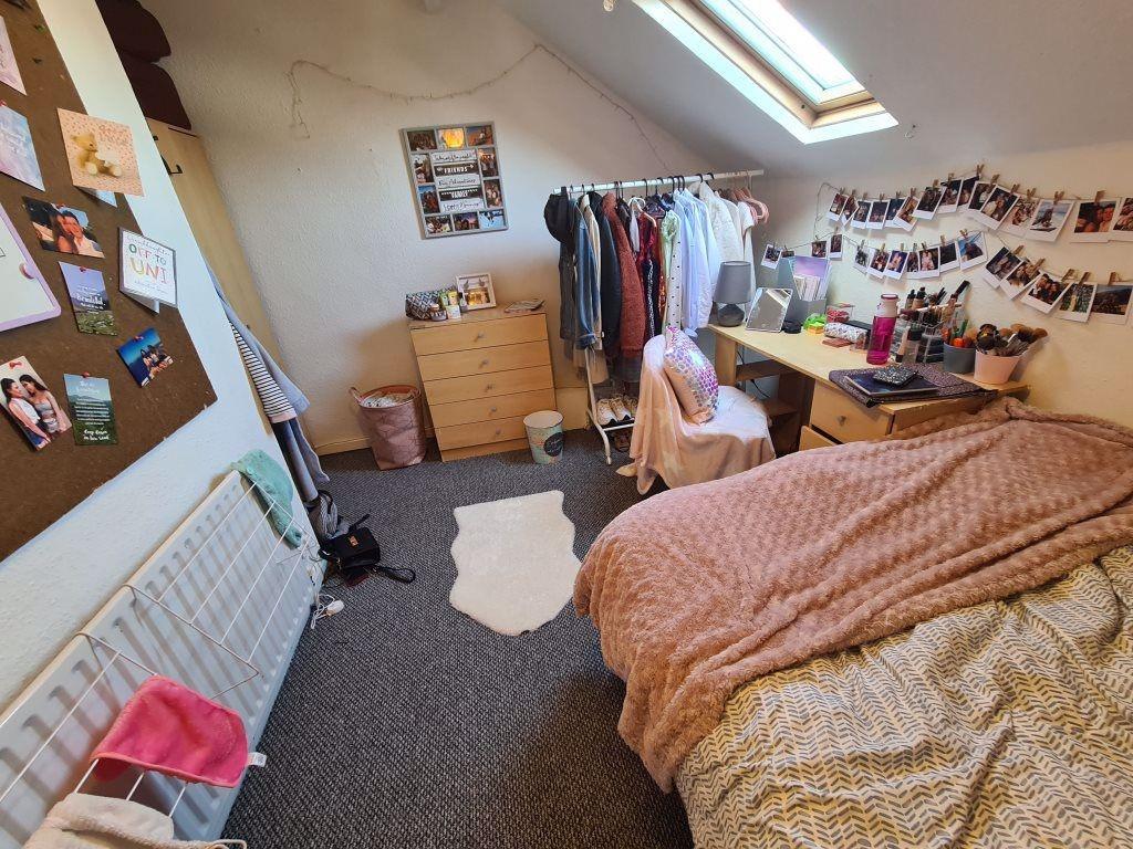 A cozy student bedroom featuring a comfortable ...