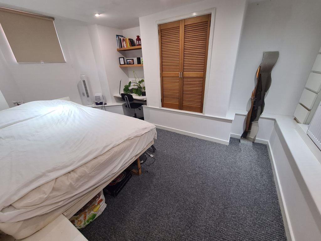 A bright, well-maintained bedroom featuring a c...