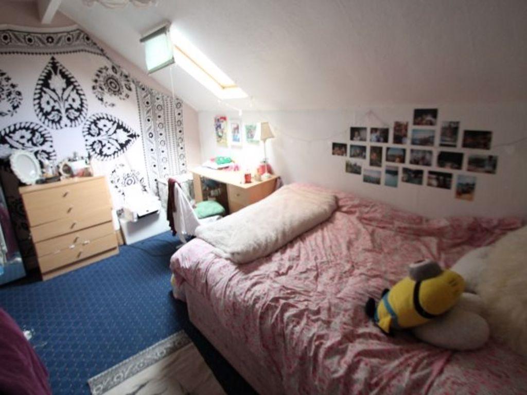 A cozy bedroom featuring a double bed with soft...