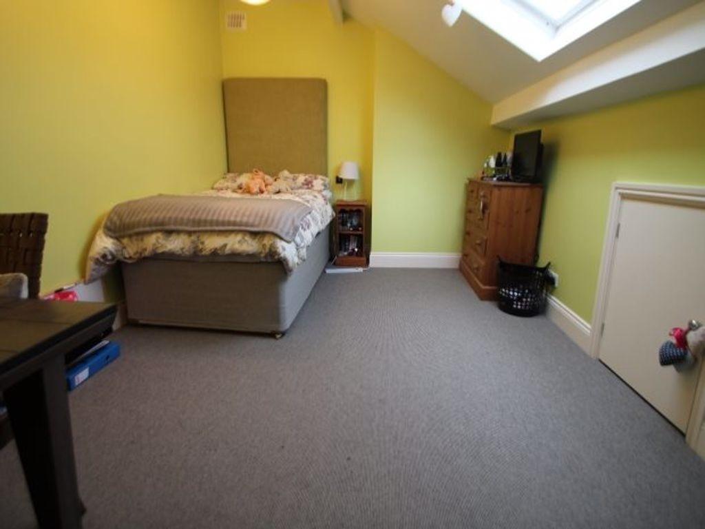 A cozy bedroom with a double bed and soft light...