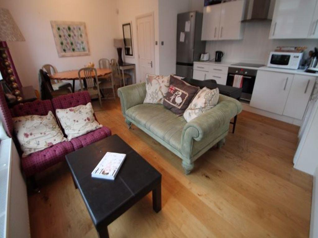 A bright and inviting living room featuring com...