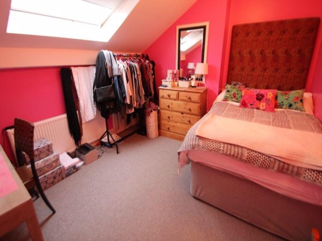A cozy double bedroom featuring a large bed wit...