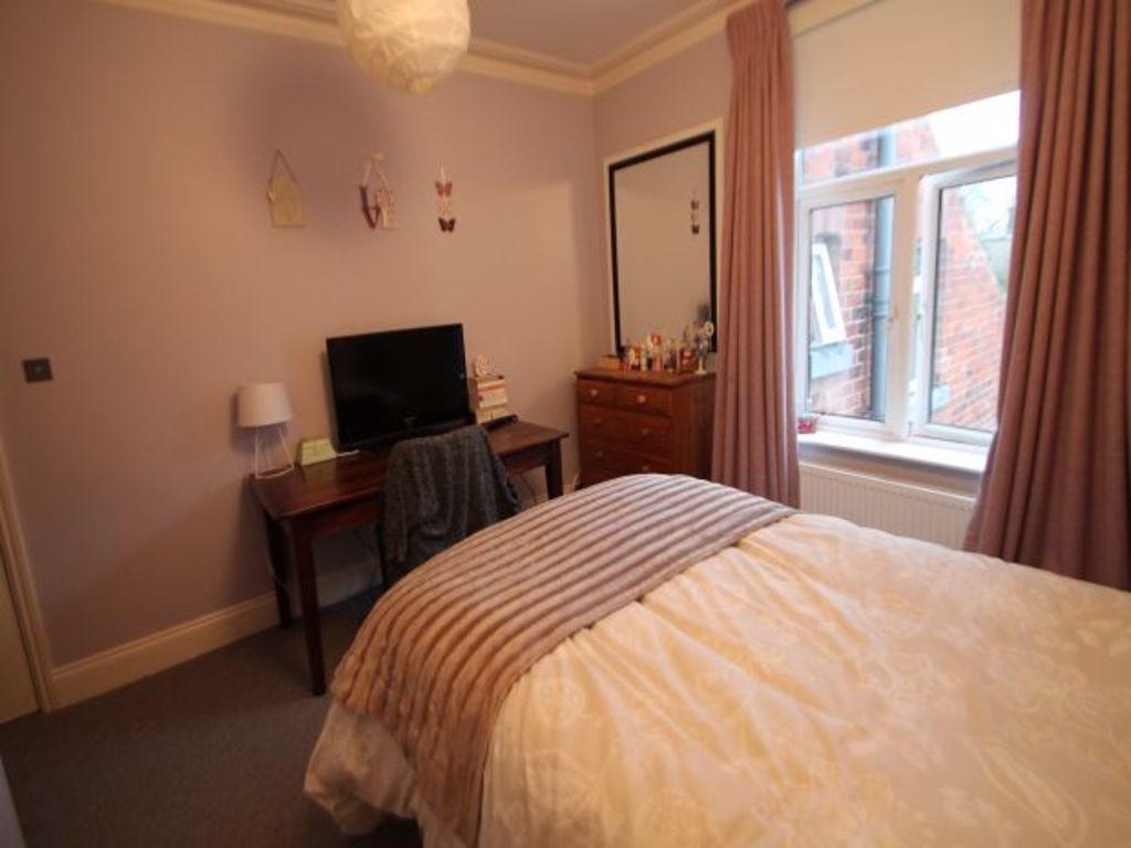 A cozy double bedroom featuring a well-made bed...