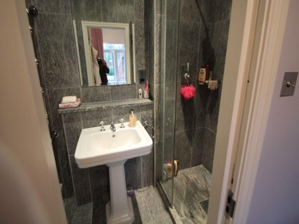 A tidy bathroom with a sink and mirror, featuri...