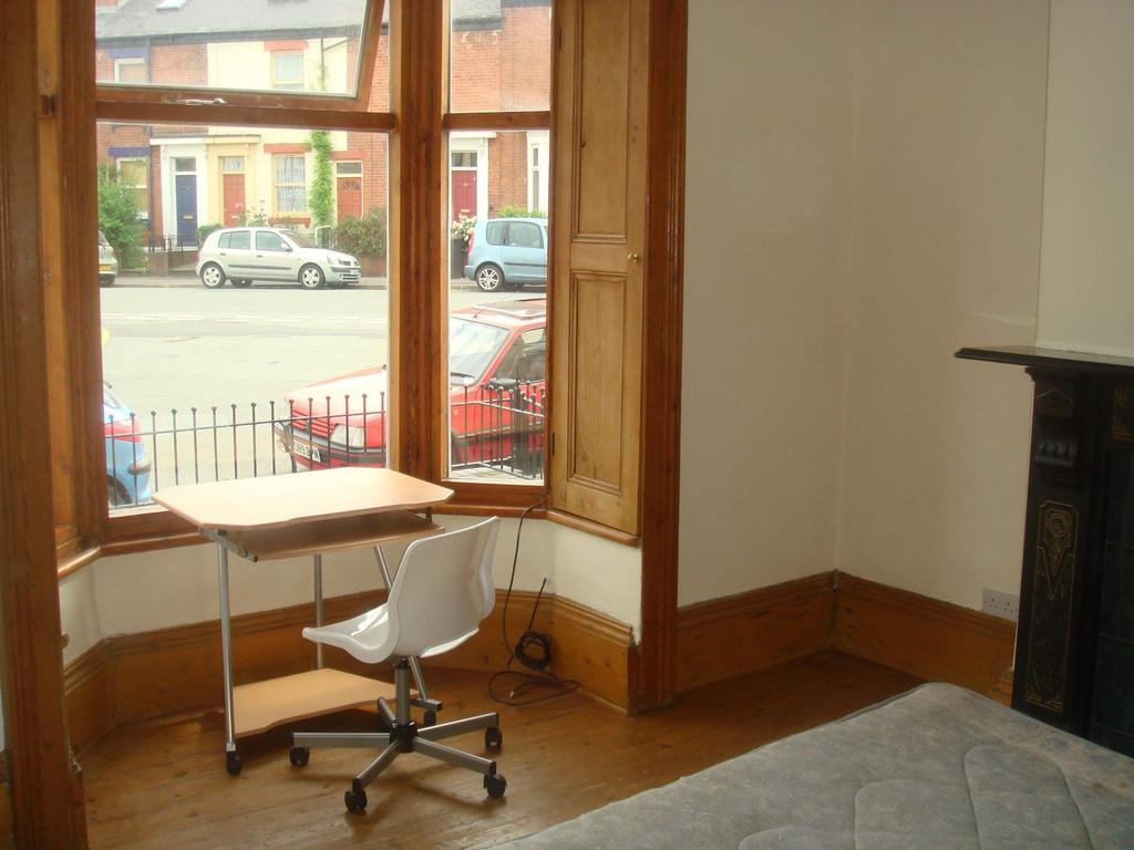 A cozy bedroom featuring a large window that al...