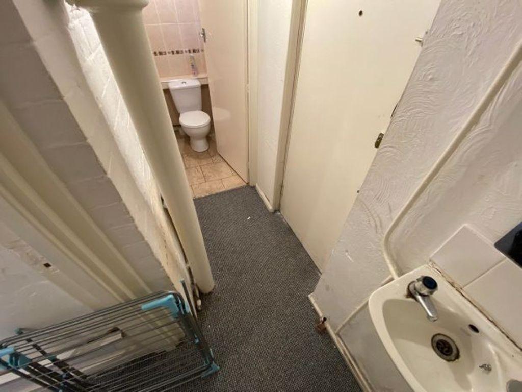 A small, functional bathroom with a sink and vi...