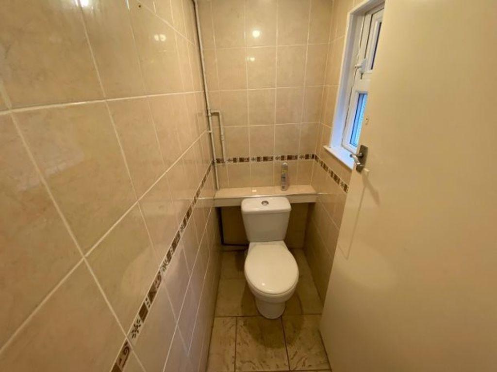 A well-maintained bathroom featuring a toilet w...