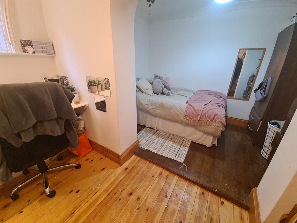 A cozy bedroom featuring a double bed with plus...