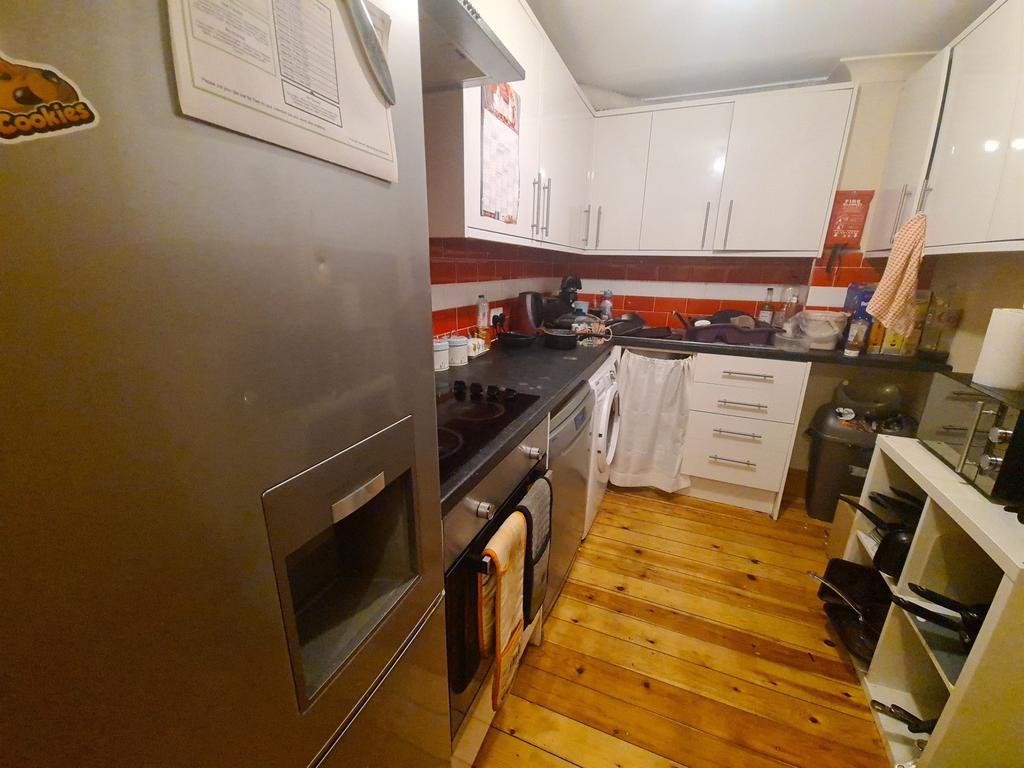 A modern, well-maintained kitchen featuring whi...