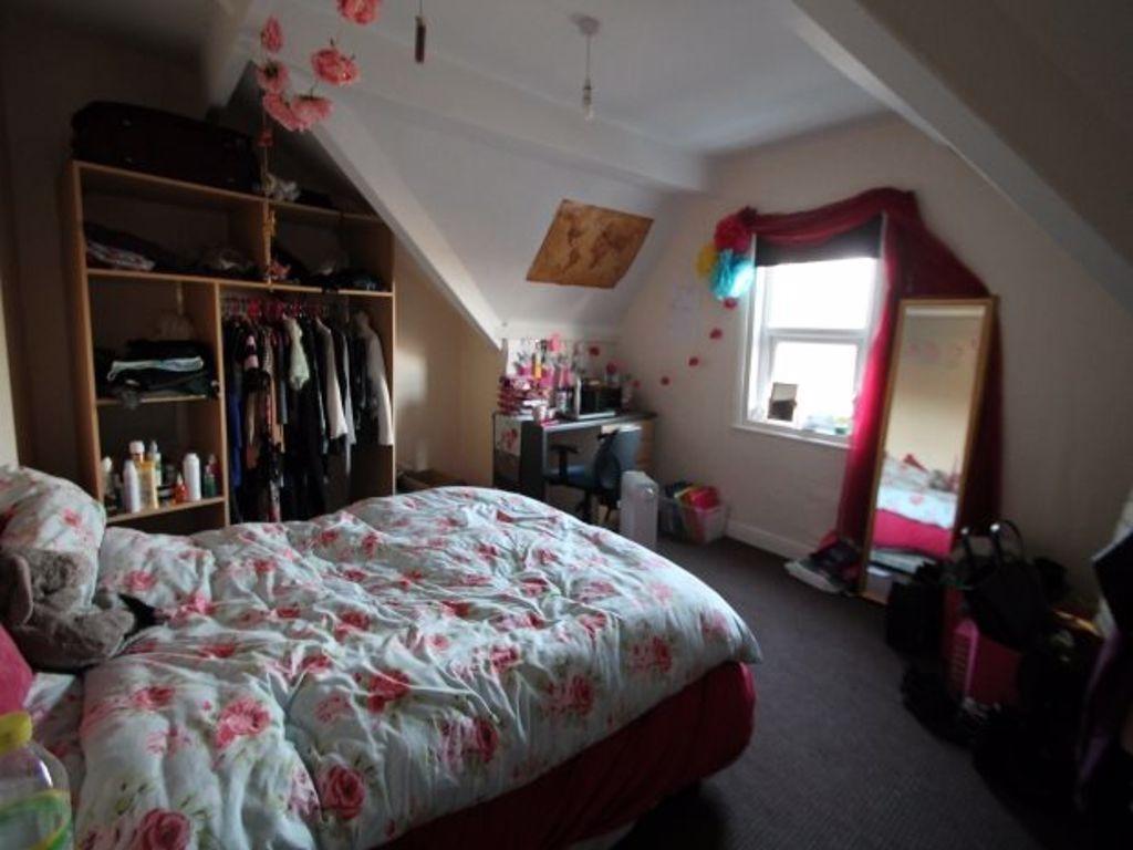 A spacious and cozy master bedroom featuring a ...