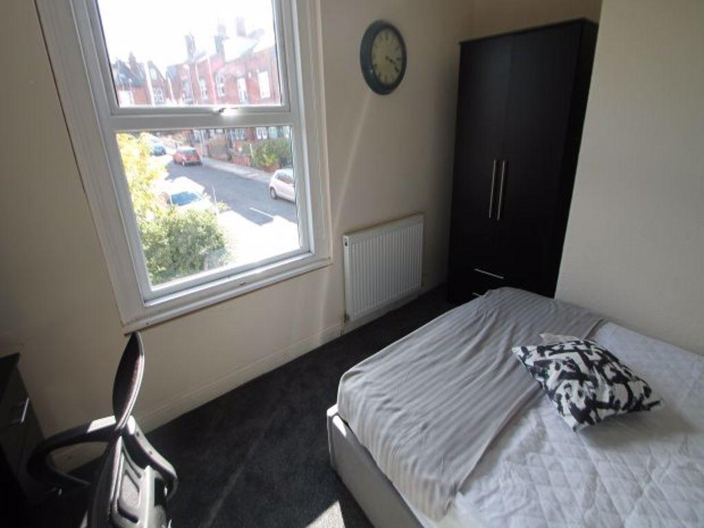 A bright and cozy bedroom with a large window p...