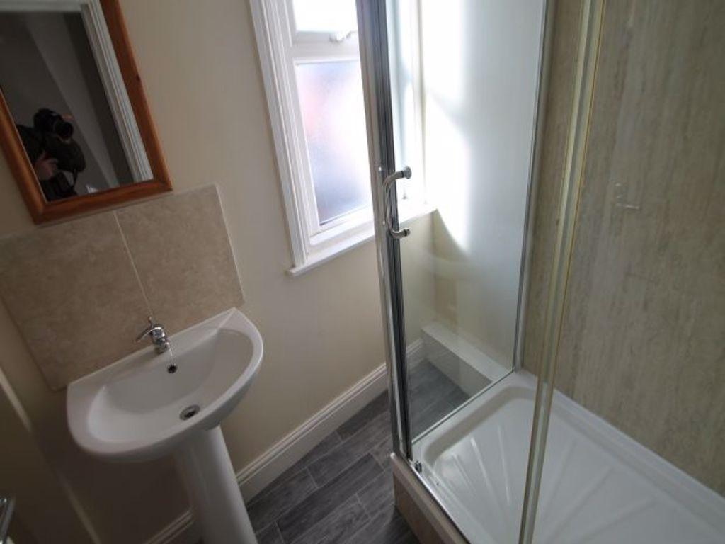 A clean and modern bathroom featuring a shower ...