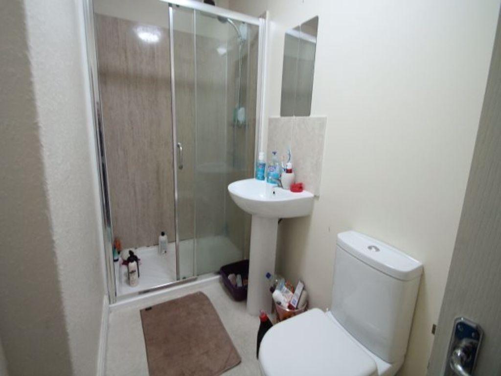 A clean and functional bathroom featuring a sho...