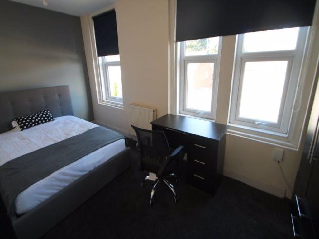 A cozy bedroom featuring a double bed with a he...