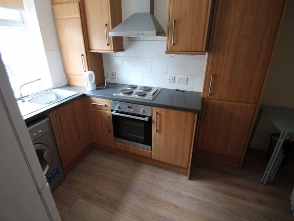 A well-maintained kitchen with wooden cabinets,...