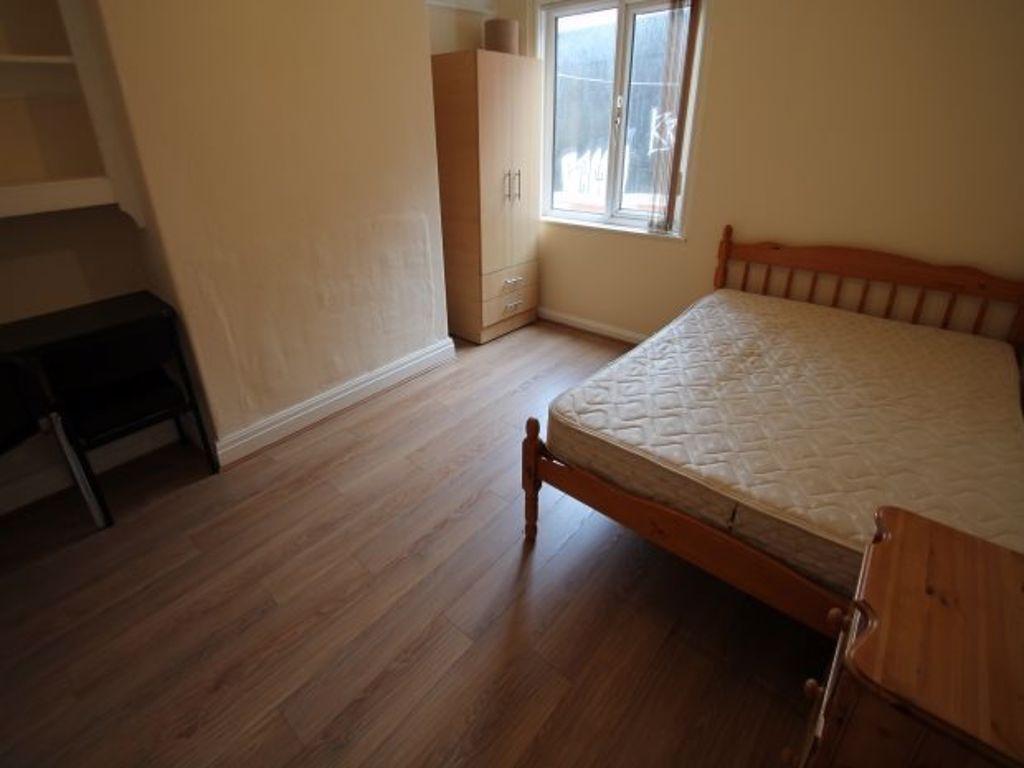 A spacious bedroom featuring a comfortable doub...