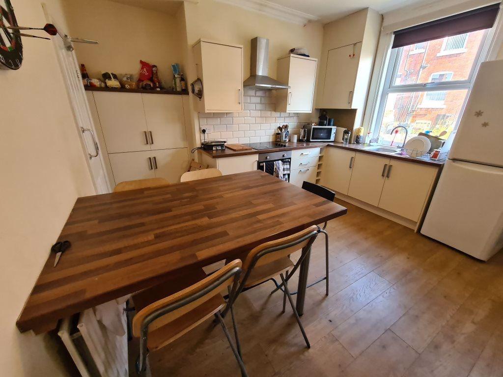 Bright and welcoming kitchen with ample natural...