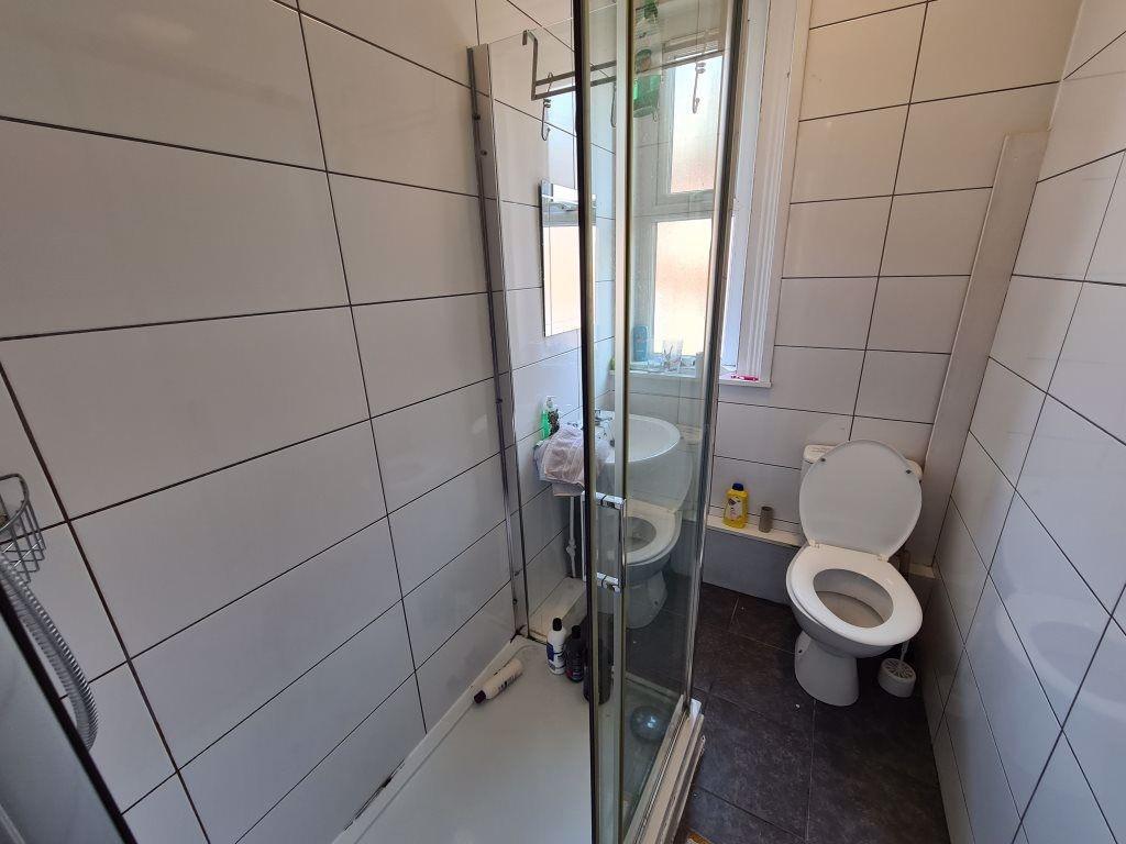 A clean and well-maintained bathroom with a sho...