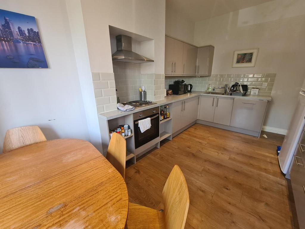 Bright and modern kitchen featuring light wood ...