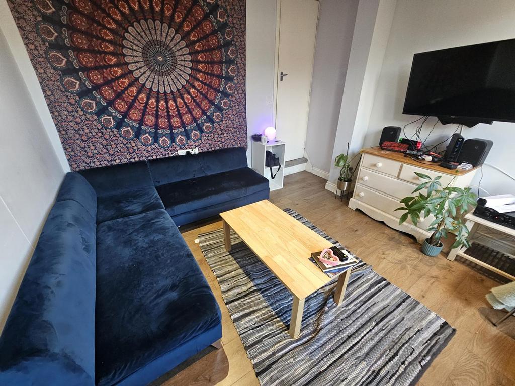 A cozy living room featuring a large dark blue ...