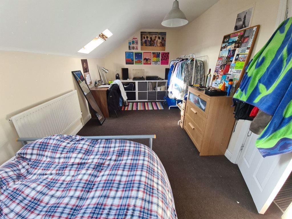 A spacious and bright bedroom featuring a doubl...