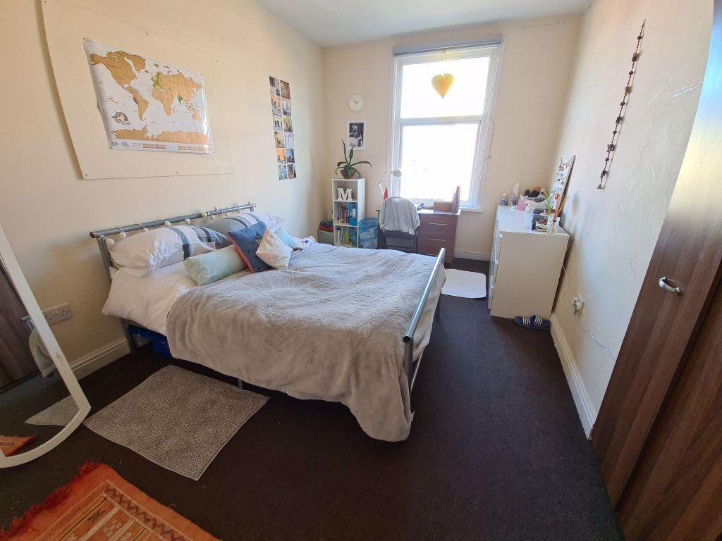 A bright and inviting master bedroom featuring ...