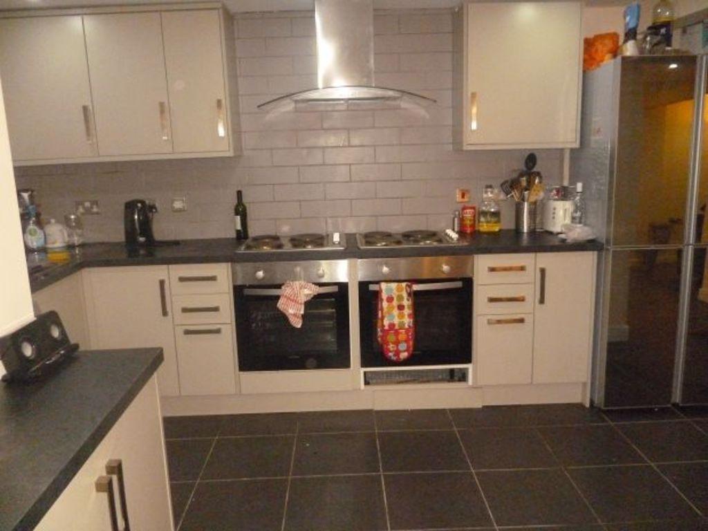 Modern and tidy kitchen with ample cabinetry, a...