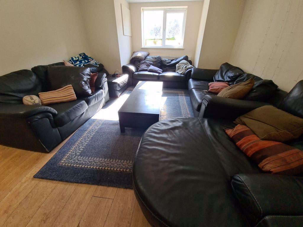 A spacious, contemporary living room featuring ...