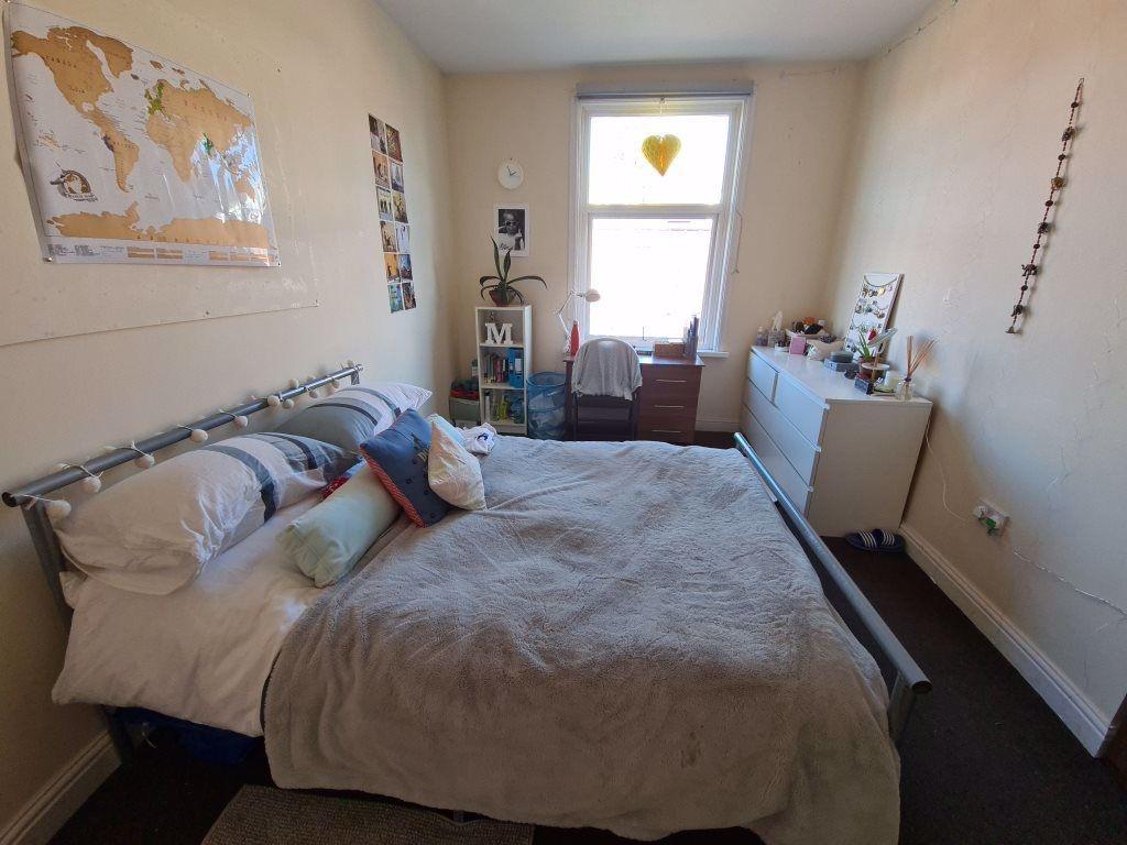 A spacious master bedroom featuring a double be...