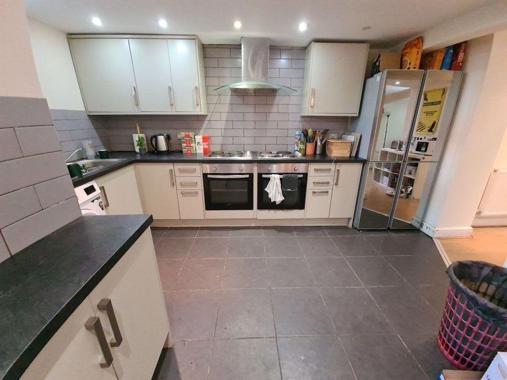 Modern and well-maintained kitchen with ample c...