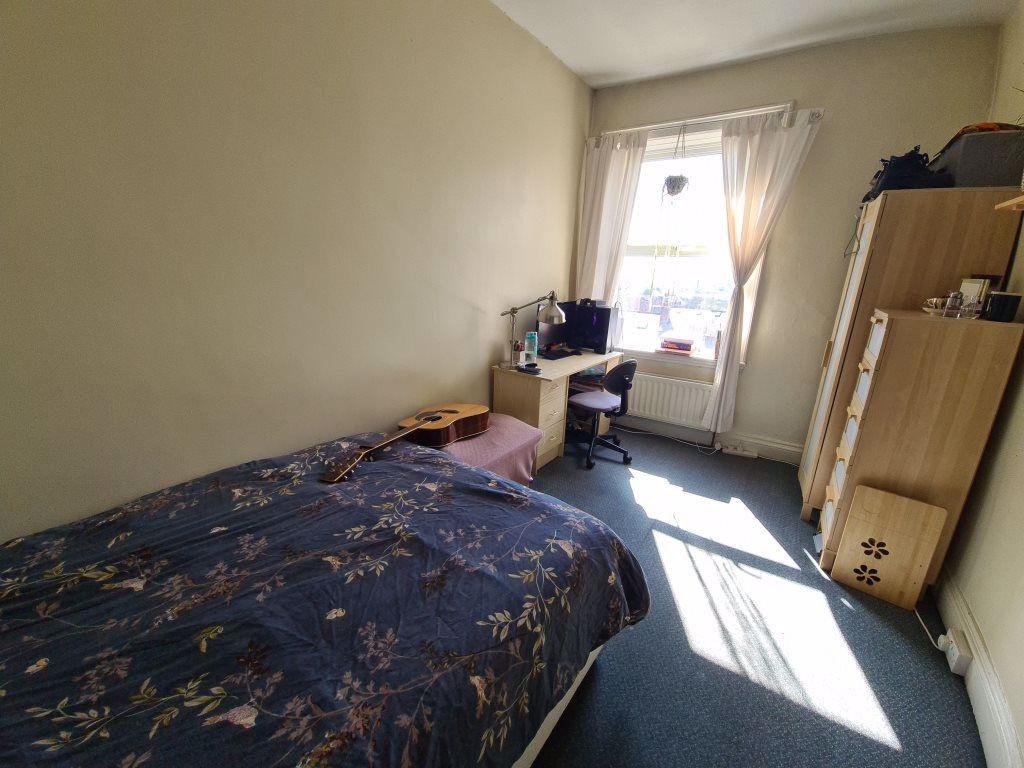 A cozy, well-lit double bedroom featuring a com...