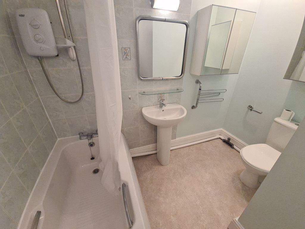 A well-maintained bathroom featuring a large sh...