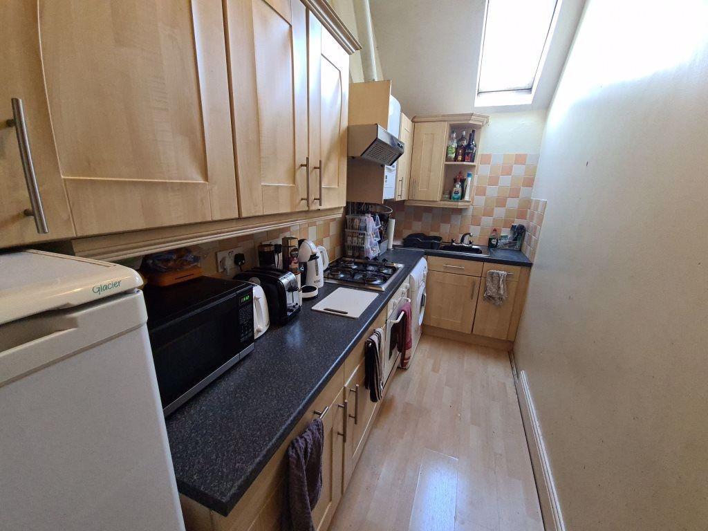 A well-maintained kitchen featuring wooden cabi...