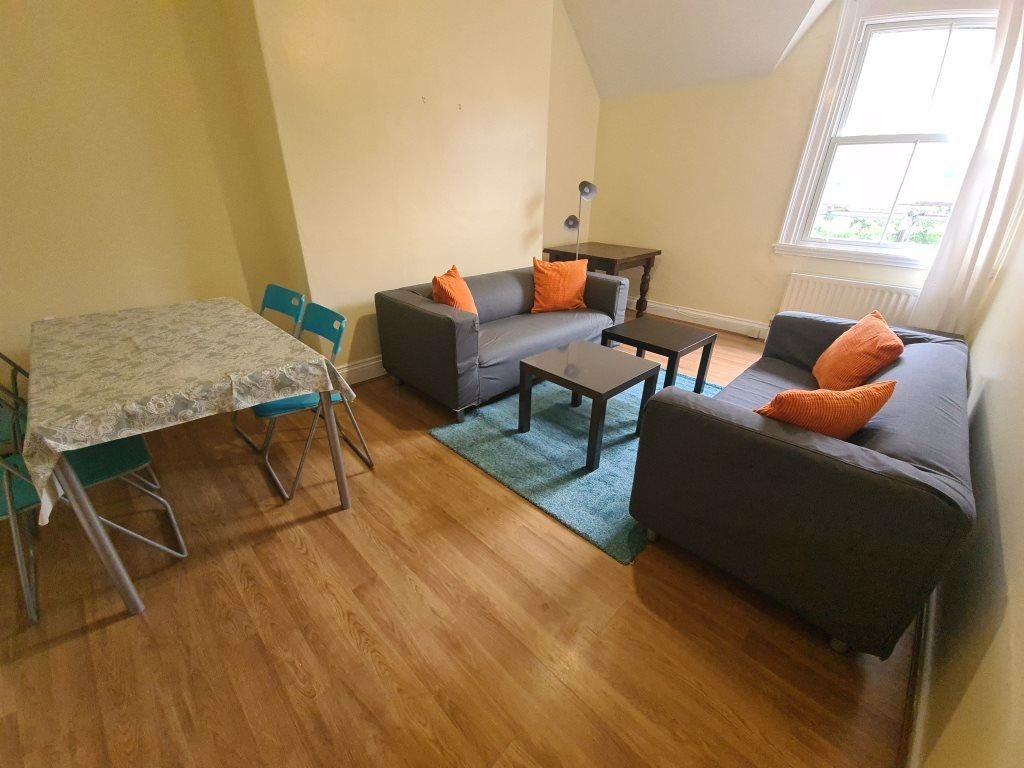 A spacious, well-lit living room with modern fu...