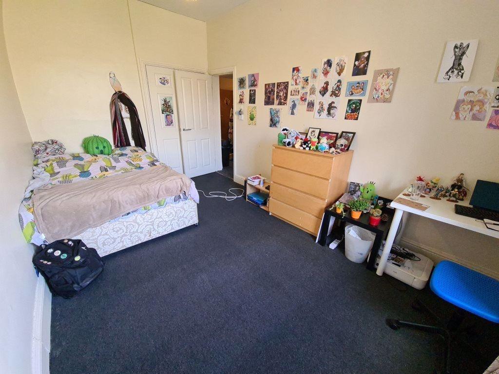 A cozy and well-maintained bedroom with a comfo...