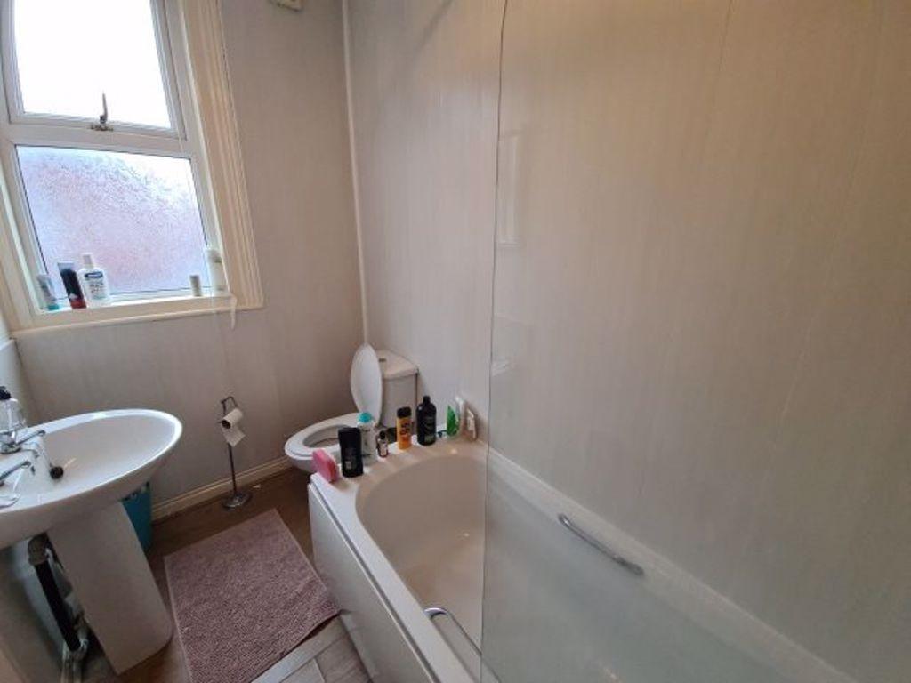 A clean and functional bathroom with a bathtub,...