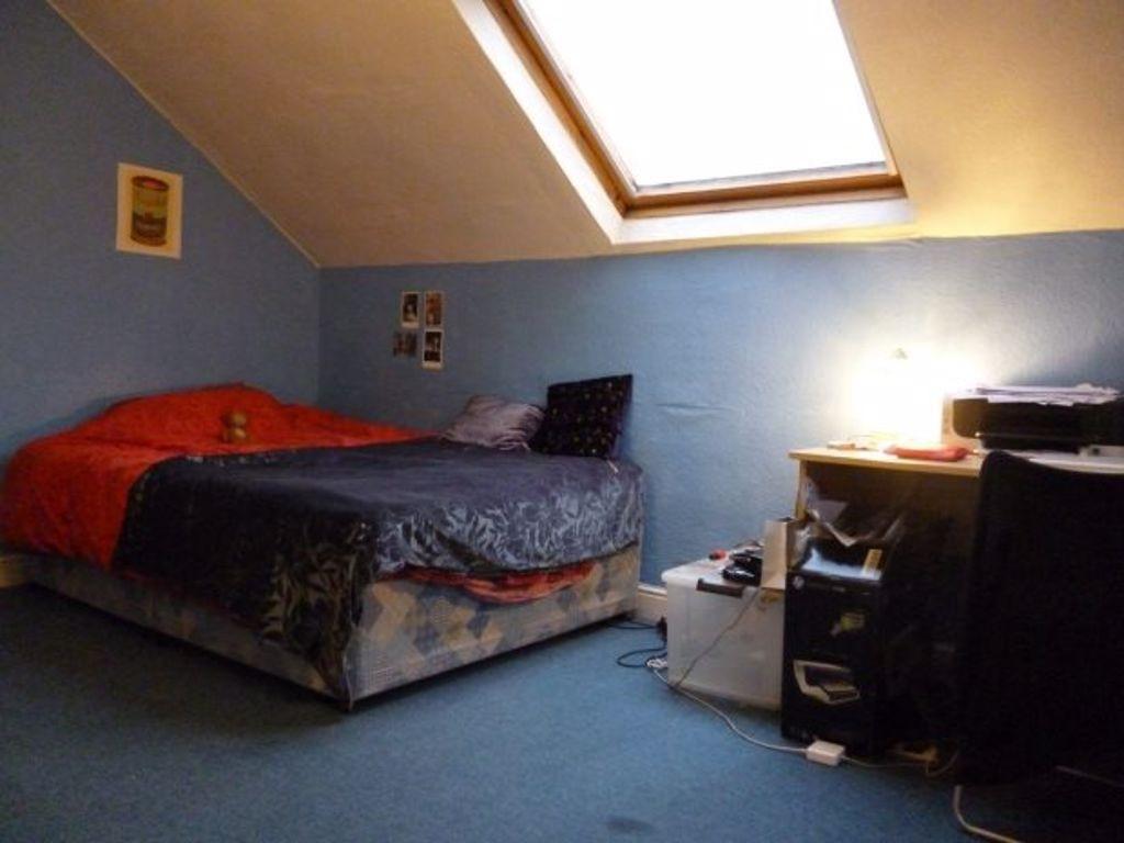 A cozy bedroom with a double bed, featuring a s...