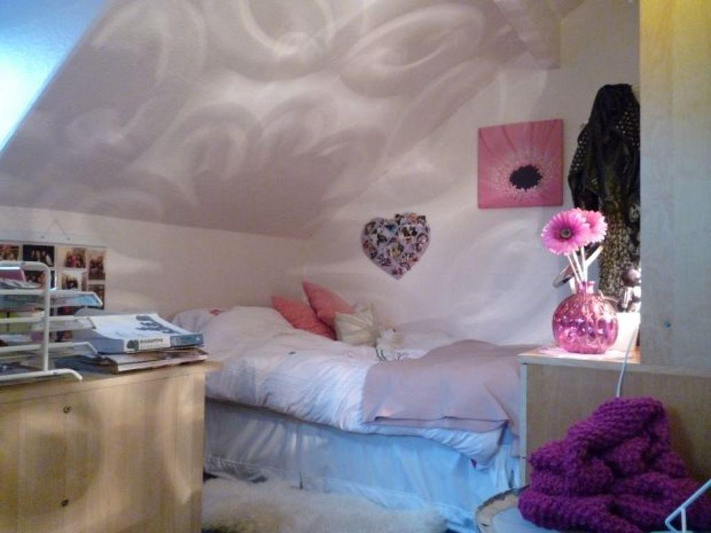 A cozy and inviting bedroom featuring a comfort...