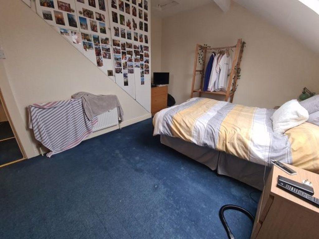 A well-presented bedroom featuring a double bed...