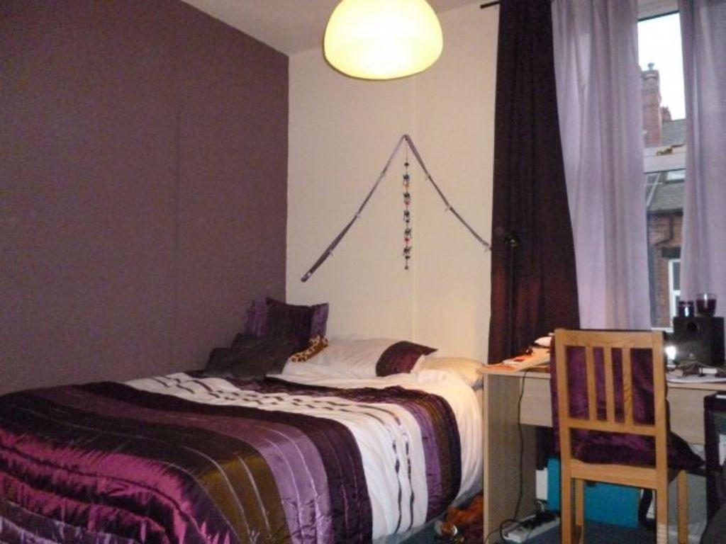 A cozy bedroom featuring a double bed with deco...
