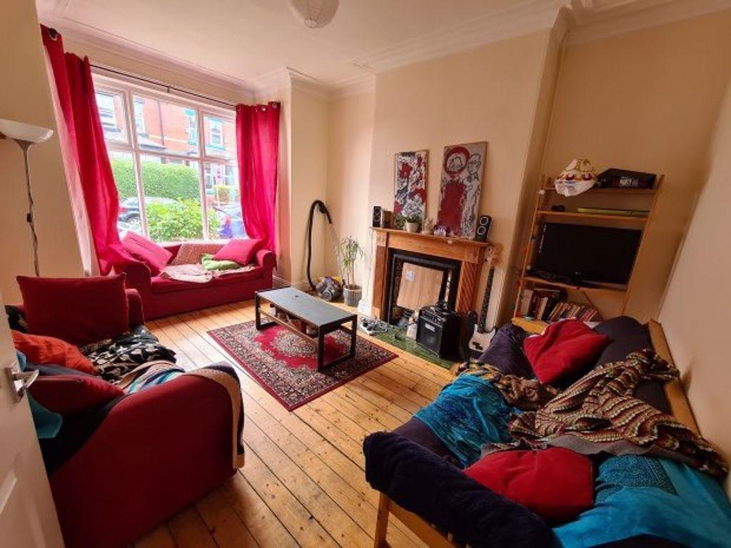 A cozy and inviting living room featuring natur...