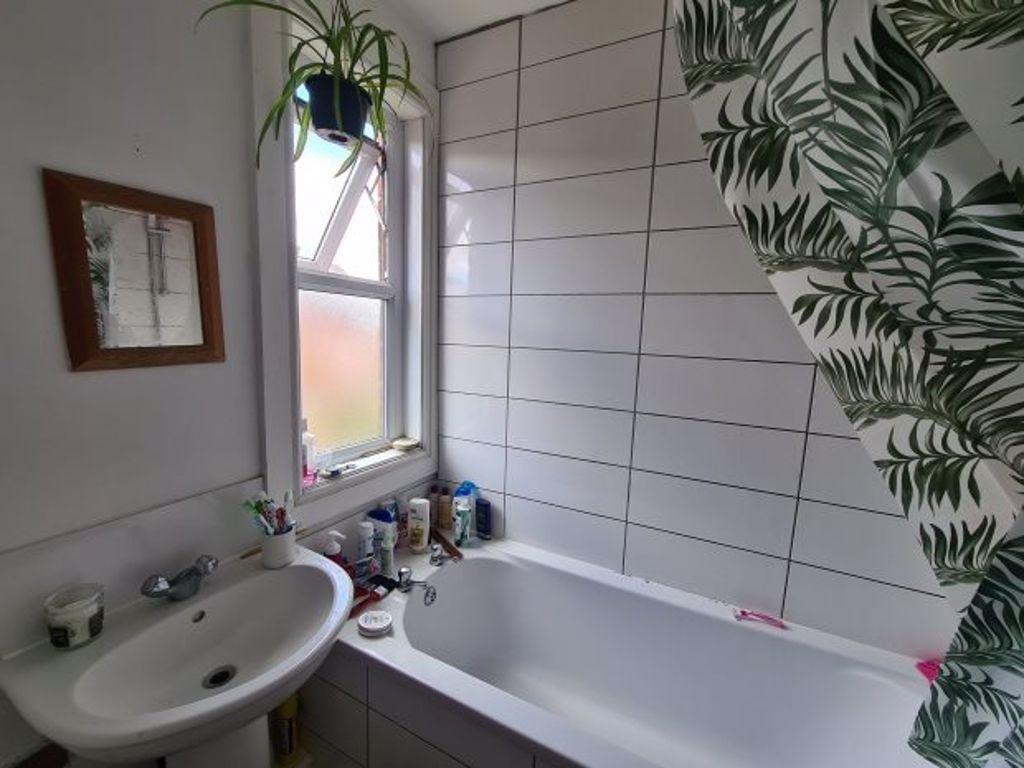 Bright and modern bathroom featuring a large ba...