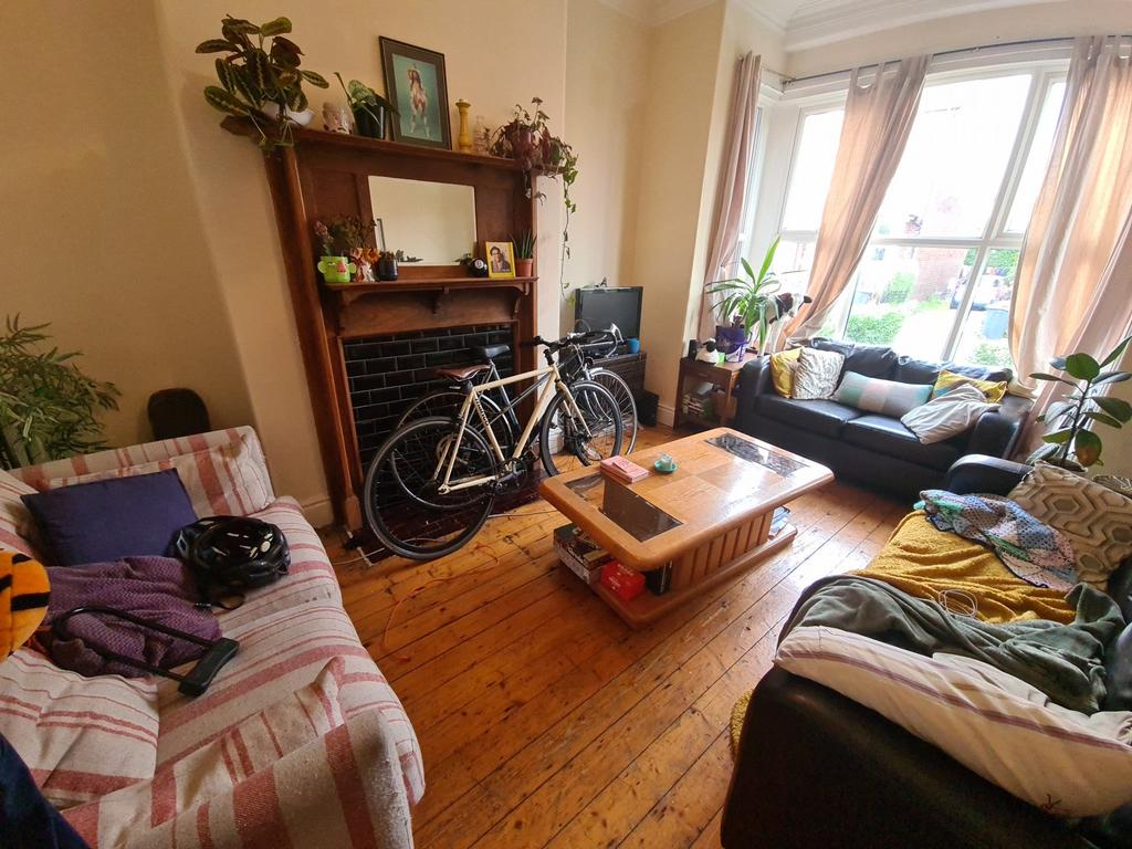 A welcoming and spacious living room filled wit...