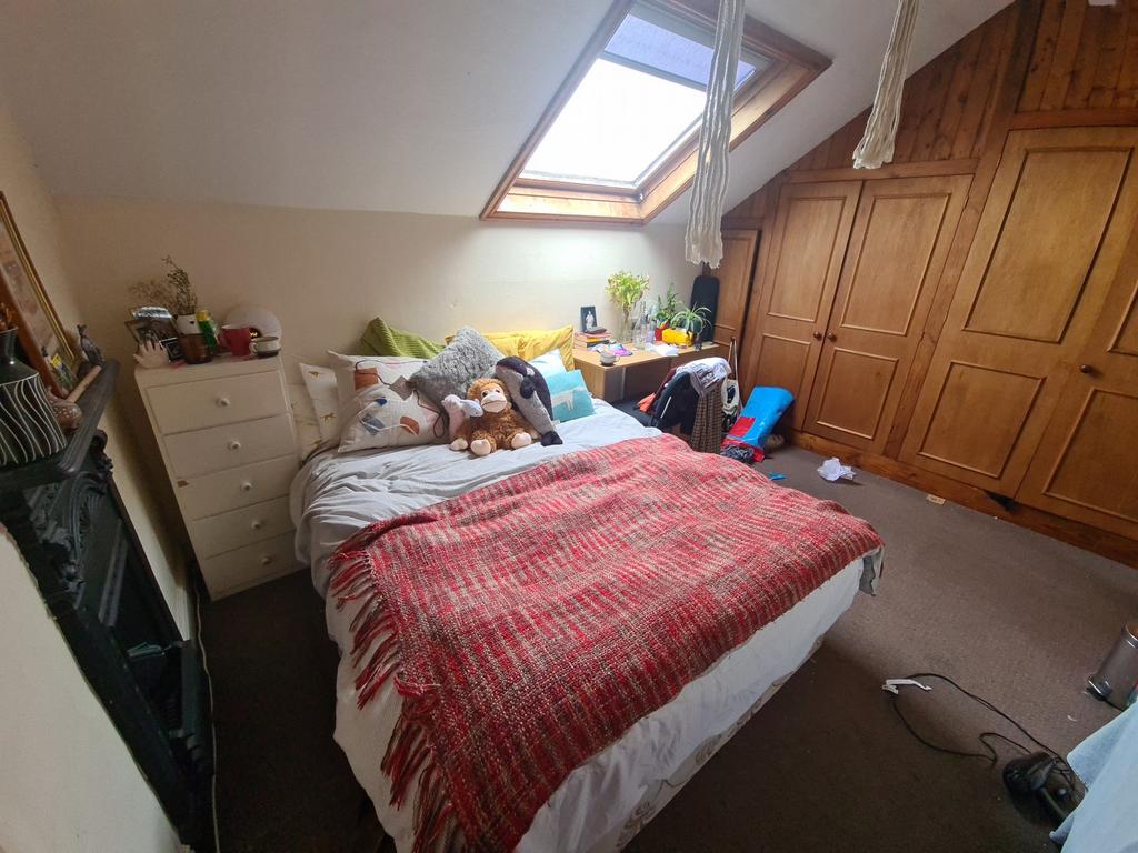 A cozy master bedroom with a comfortable bed, a...