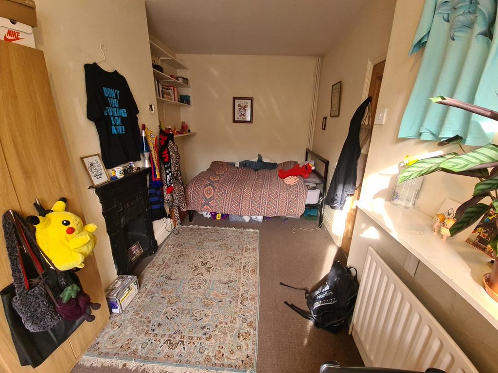 A spacious and well-lit master bedroom featurin...