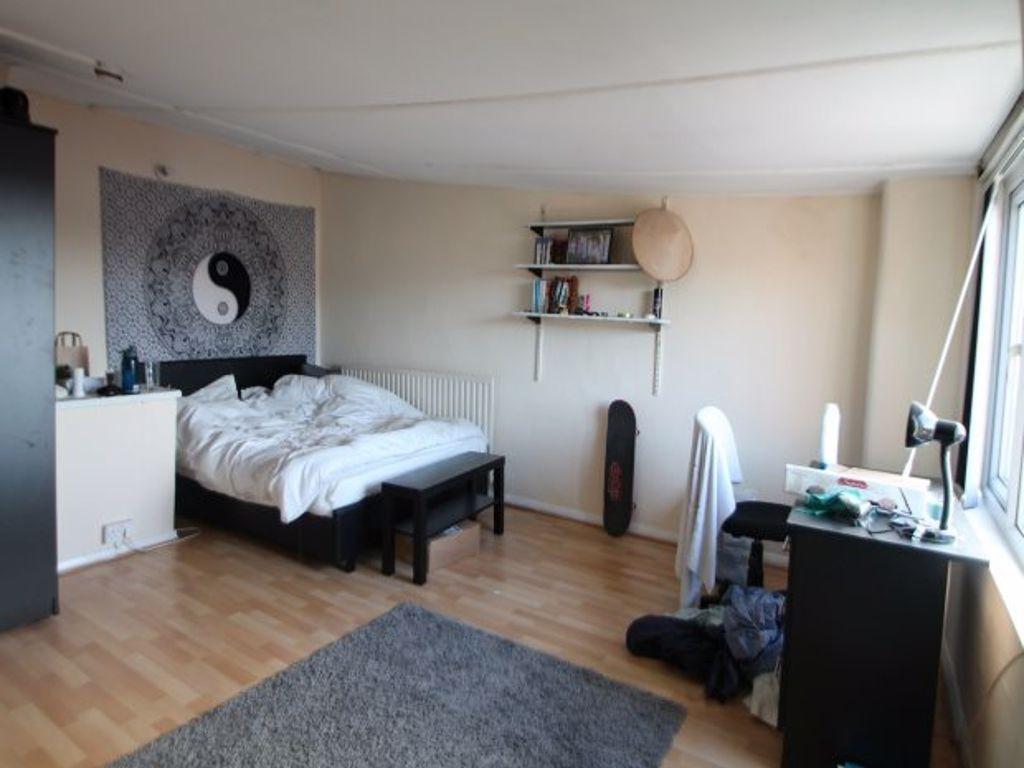 A bright and comfortable bedroom featuring a do...