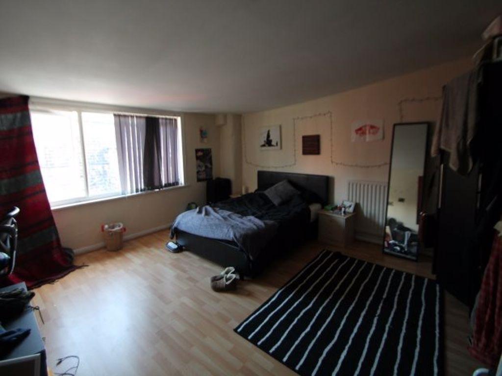 A cozy bedroom featuring a double bed, a large ...