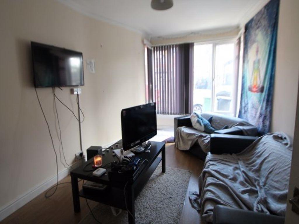 A spacious and well-lit living room featuring m...