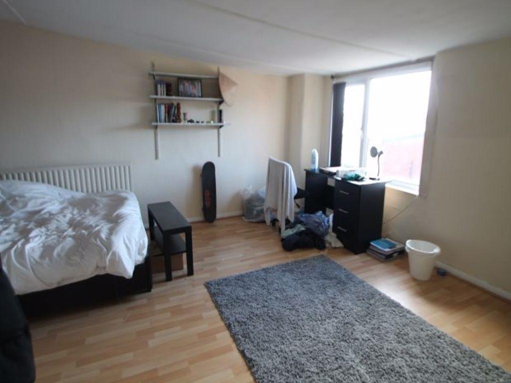 A bright and inviting bedroom with ample space ...