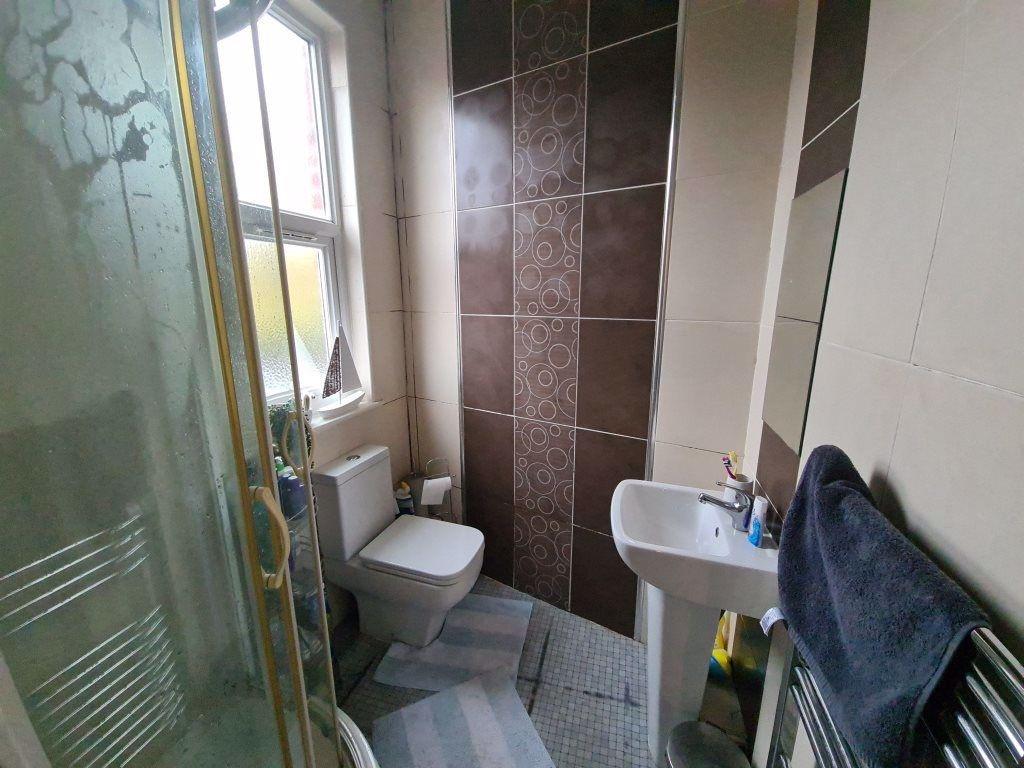 A clean and well-lit bathroom featuring a toile...